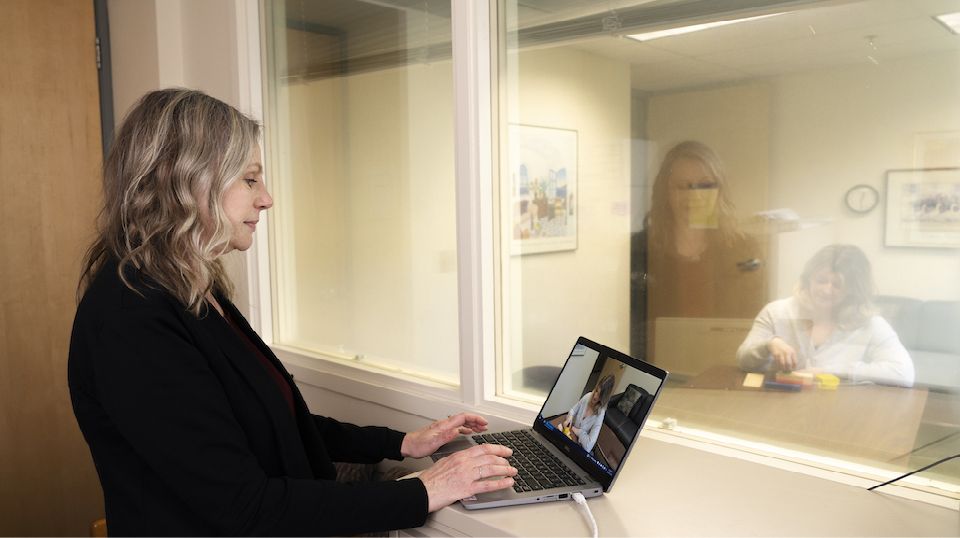UVic staff member in front of a computer