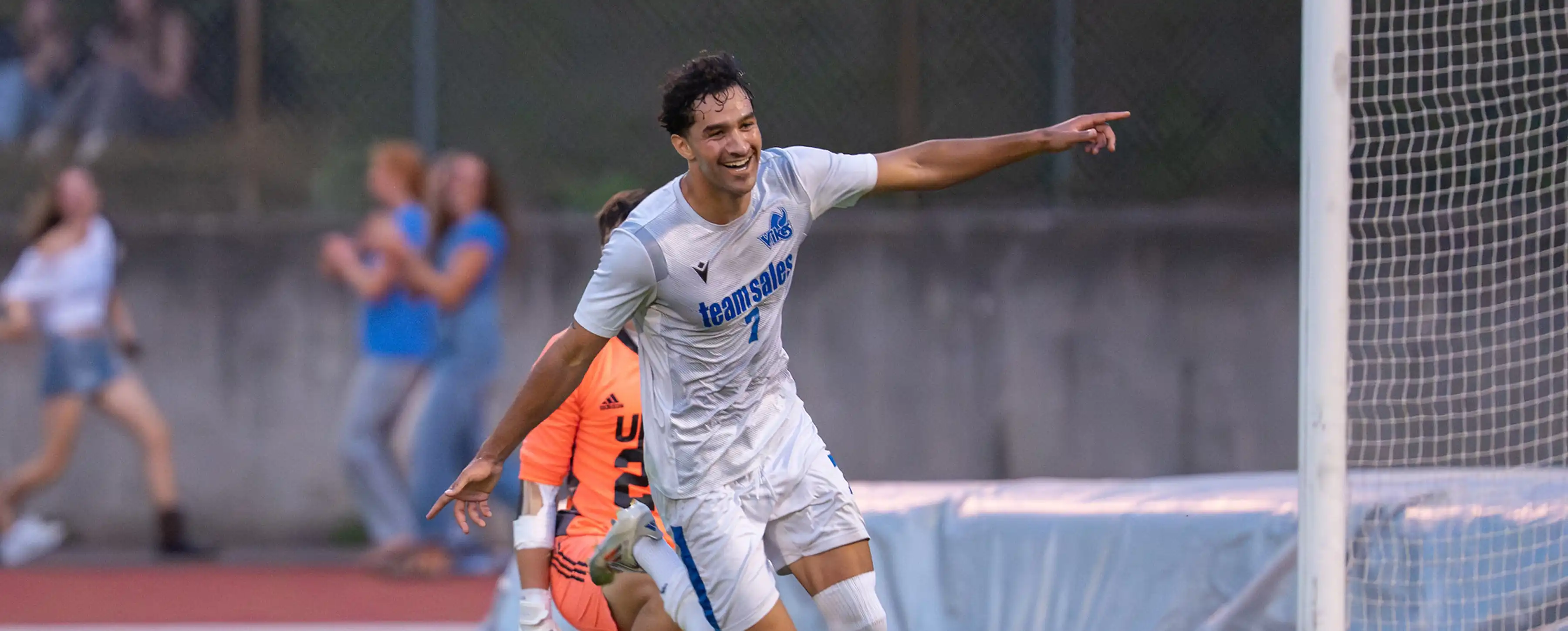 A student soccer athlete celebrates a goal.