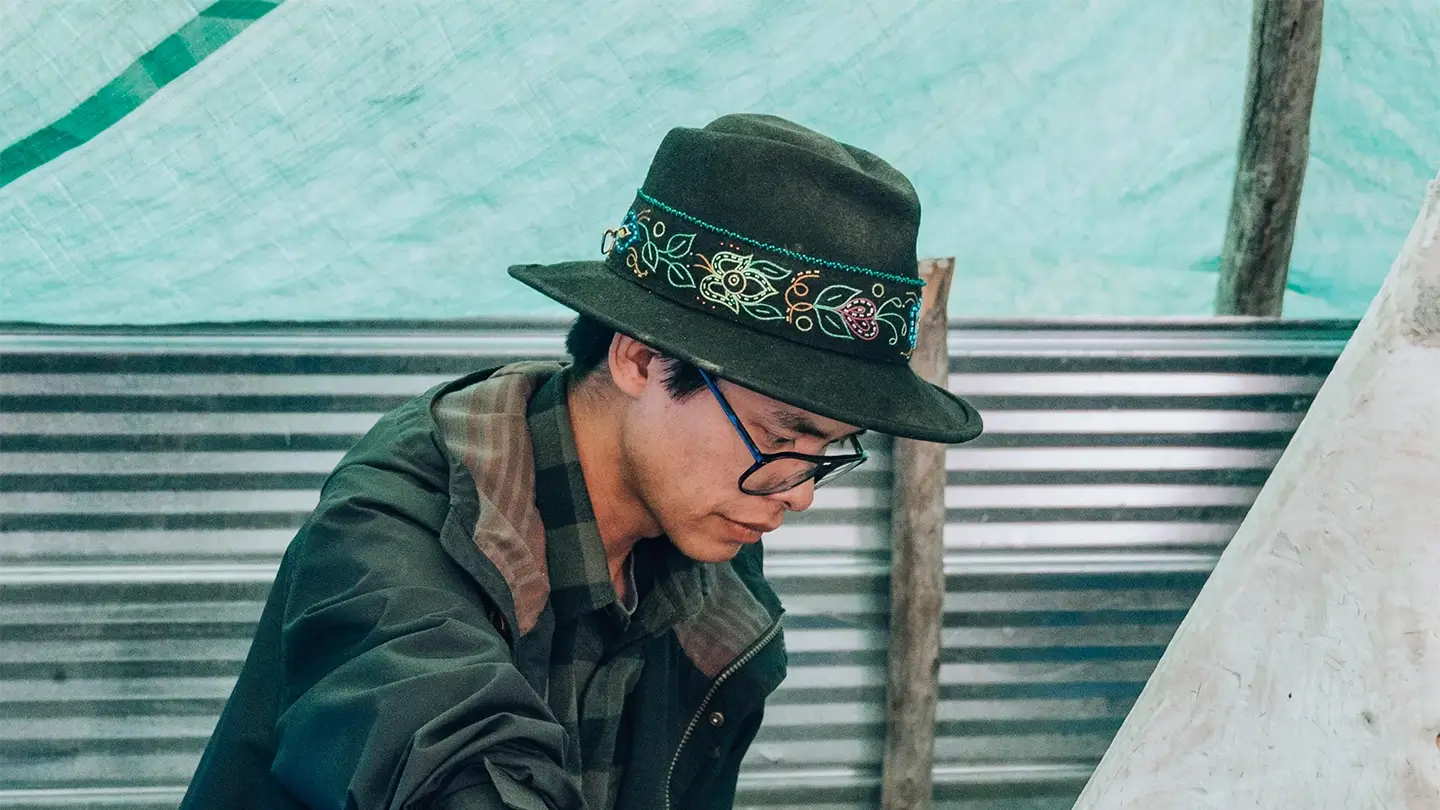 Arlyn Charlie tanning moose hide.