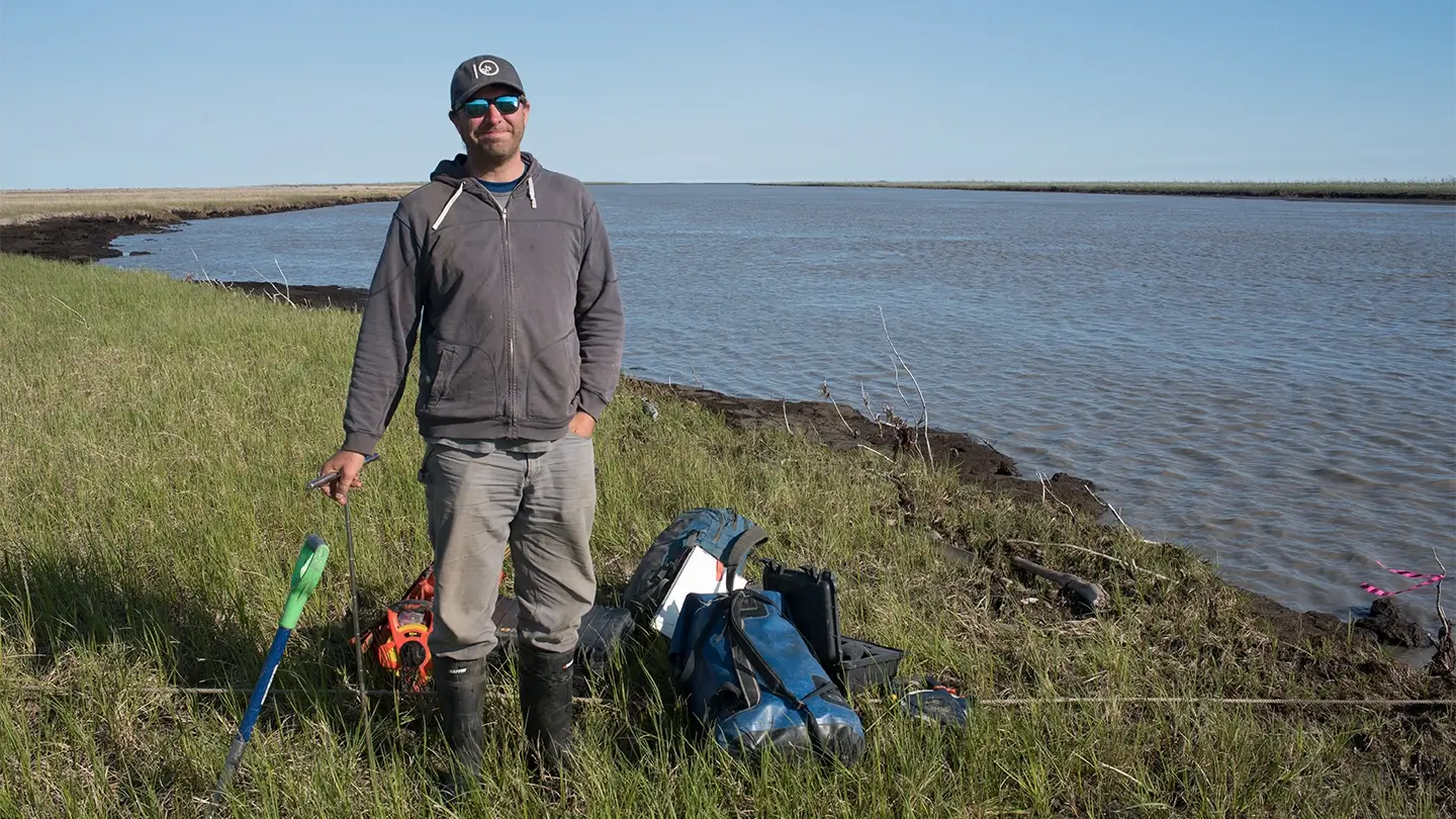 Person standing on shoreline of a lake