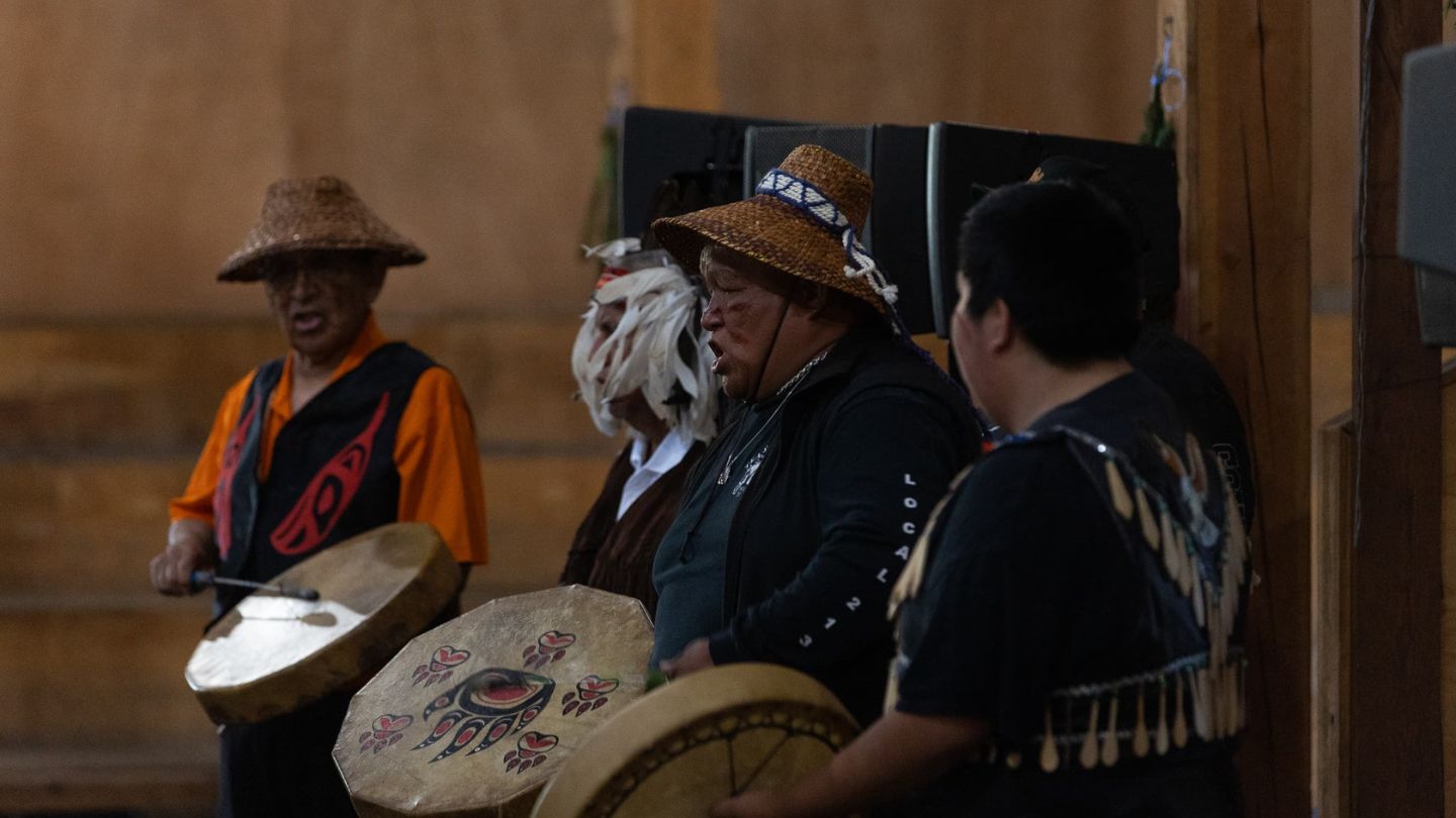 Members of an Indigenous drum group sing and drum during Dr. Robina Thomas's honouring ceremony.