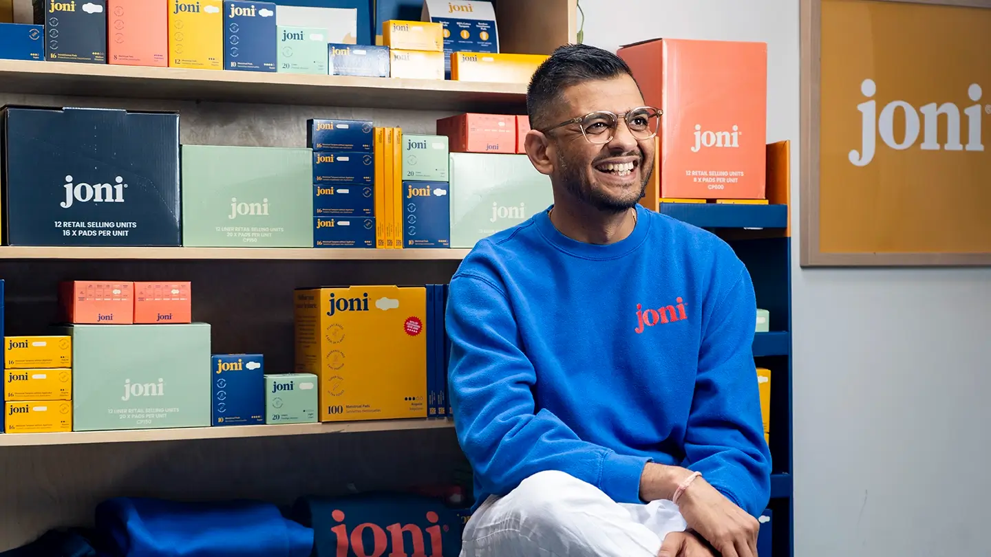 Jayesh Vekariya sits with joni product boxes.